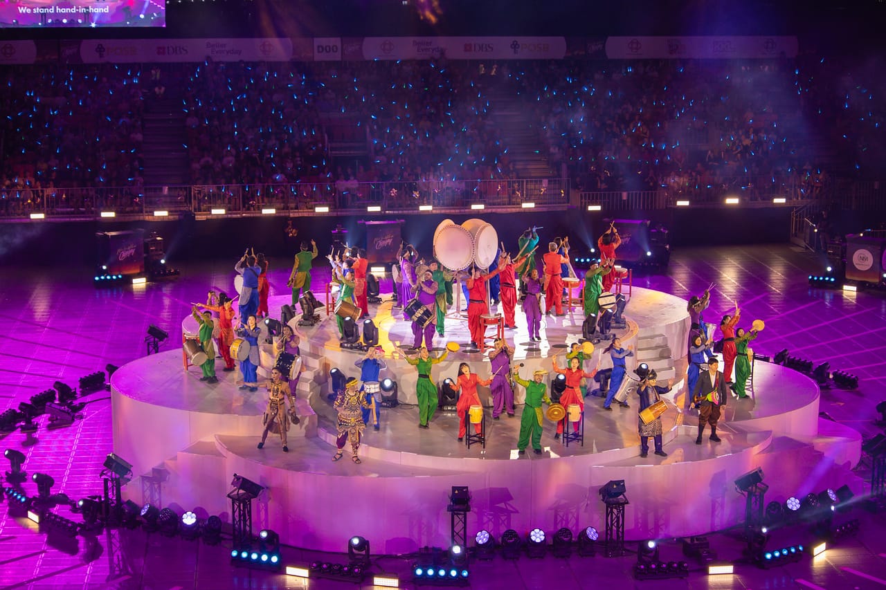 Large group of people performing on stage